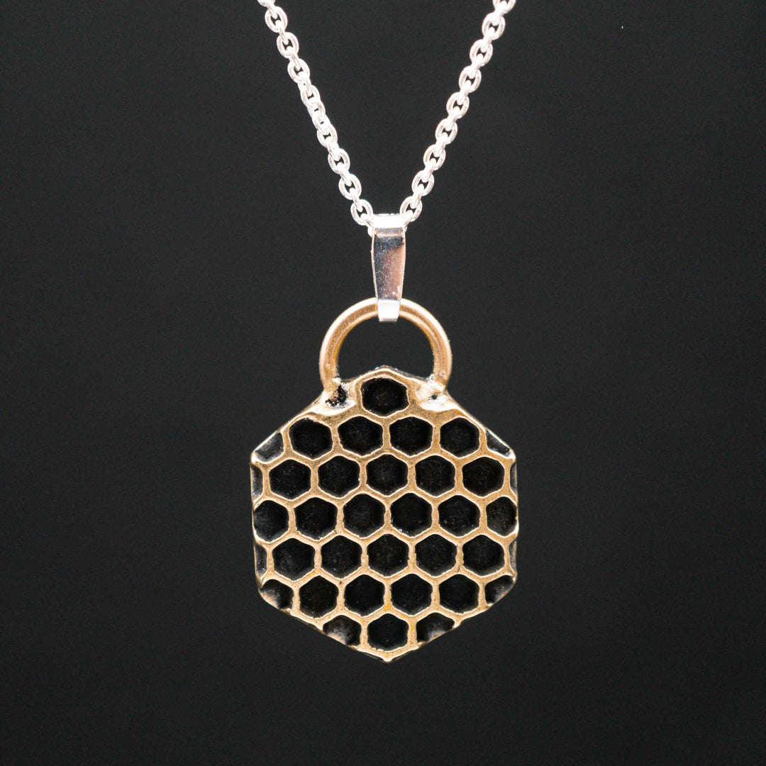 Golden honeycomb bee necklace made of bronze