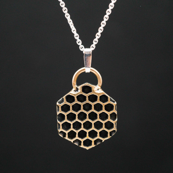 Golden honeycomb bee necklace made of bronze