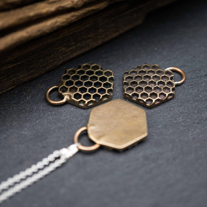 Golden honeycomb bee necklace made of bronze
