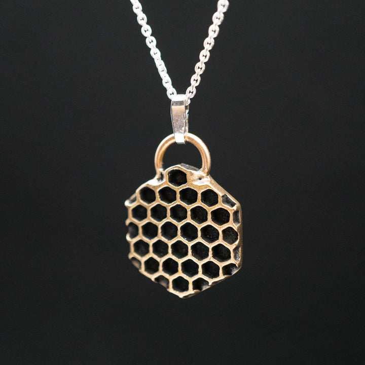 Golden honeycomb bee necklace made of bronze