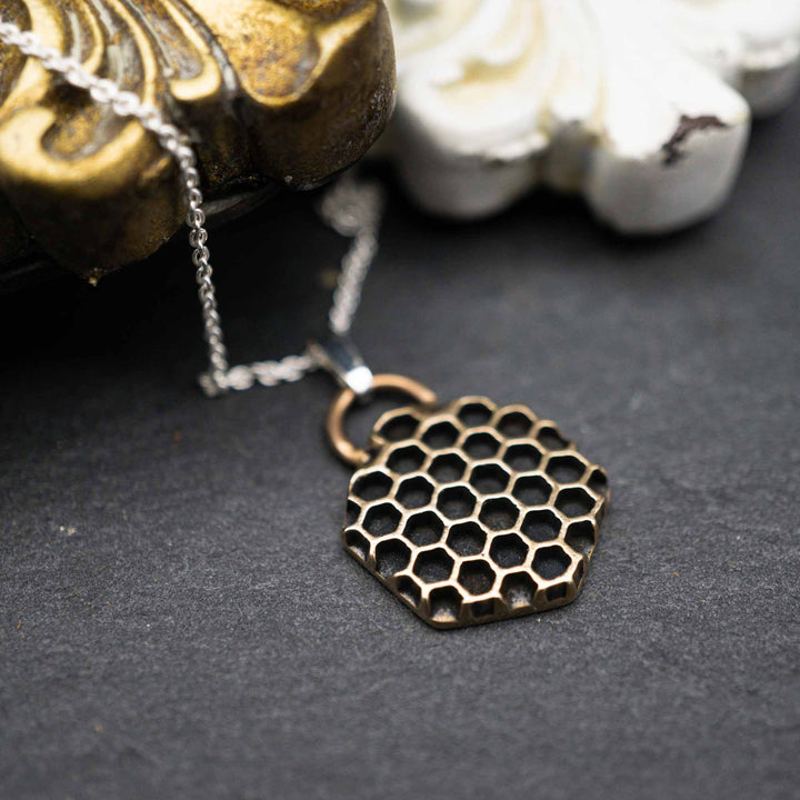 Golden honeycomb bee necklace made of bronze