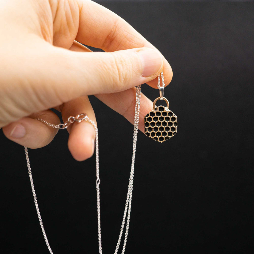 Golden honeycomb bee necklace made of bronze