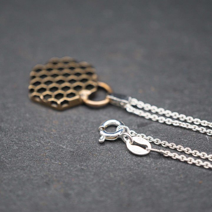 Golden honeycomb bee necklace made of bronze